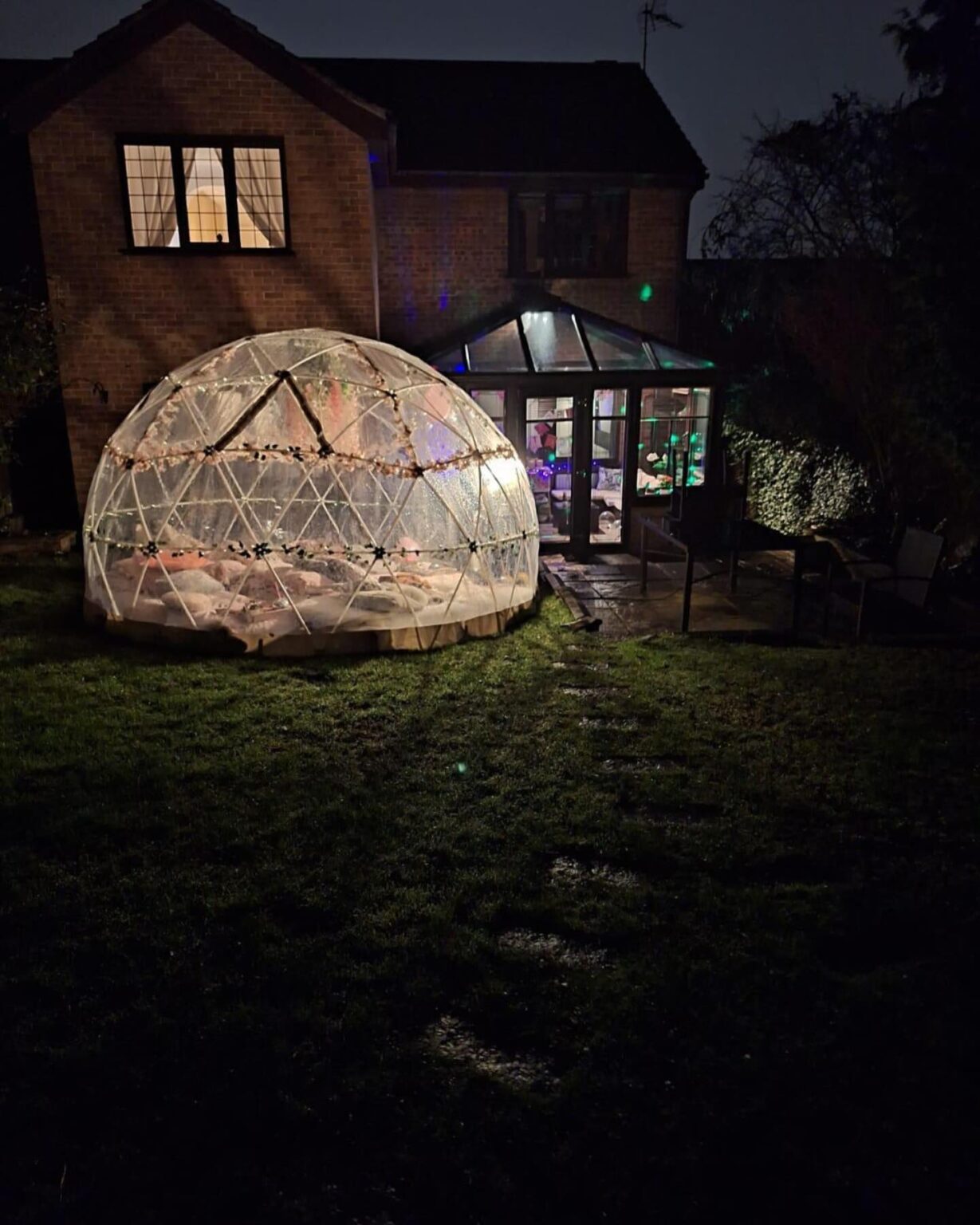 Partyigloos dome lit up at night in a garden
